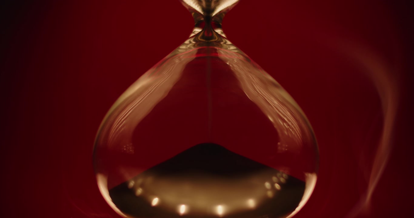 Smoke slowly wrapping an hourglass