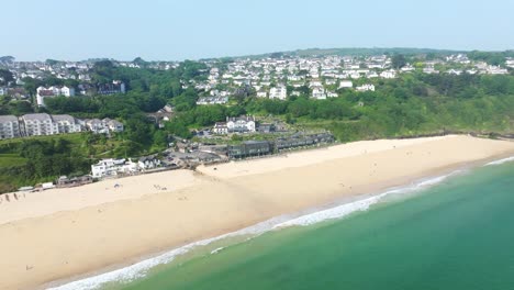 Carbis-Bay-in-Cornwall-with-an-Aerial-Drone-Shot-Along-the-Coastal-Beach-and-Turquoise-Waters,-England,-UK