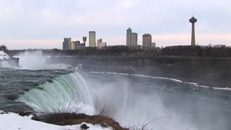 The-Tourist-Hotels-And-Viewing-Tower-Look-Stark-Against-A-Pale-Sky-With-Niagara-Falls-In-The-Foreground