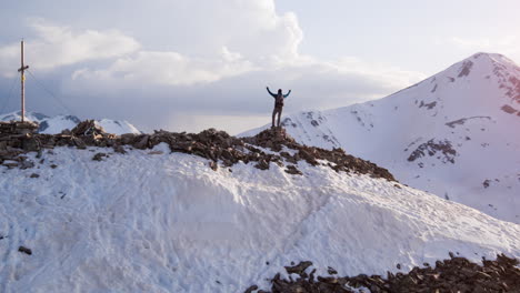 hiker on mountain summit at sunrise/sunset