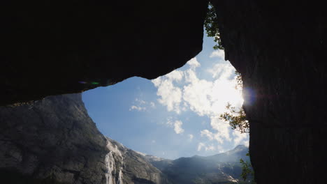 a view of the high mountains with a waterfall flowing from the top the nature of norway and scandina