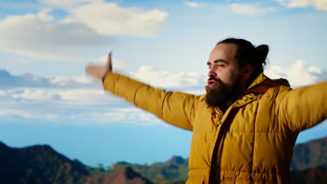 adventure seeker stands on top a high altitude mountain for a breathtaking view