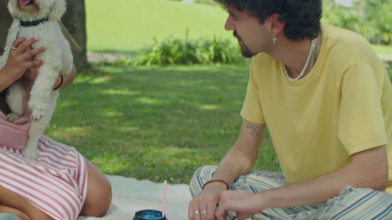 Girl Taking Photo with Dog on Picnic with Friends in Park