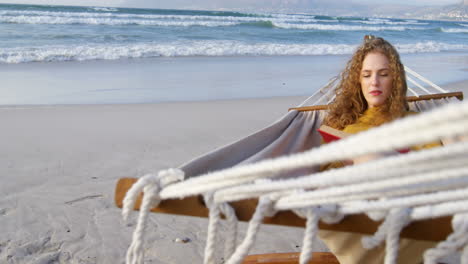 Woman-reading-a-book-in-hammock-at-beach-4k