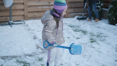 grandfather and granddaughter having fun in the snow