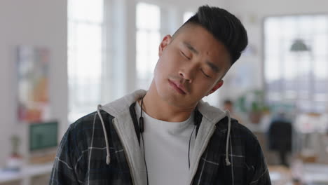 portrait young asian businessman smiling making faces enjoying silly fun in office workspace