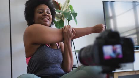 african american female plus size vlogger recording a video about working out