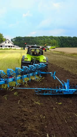 tractor working in the agricultural field. agricultural equipment ready for ploughing the fields vertical video