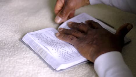 man praying to god with hands together with bible caribbean man praying with white background stock footage