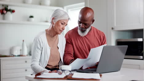 senior couple, bills and documents on laptop