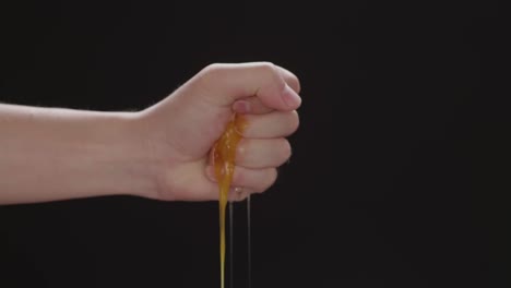 squeeze the chicken egg peeling on a black background