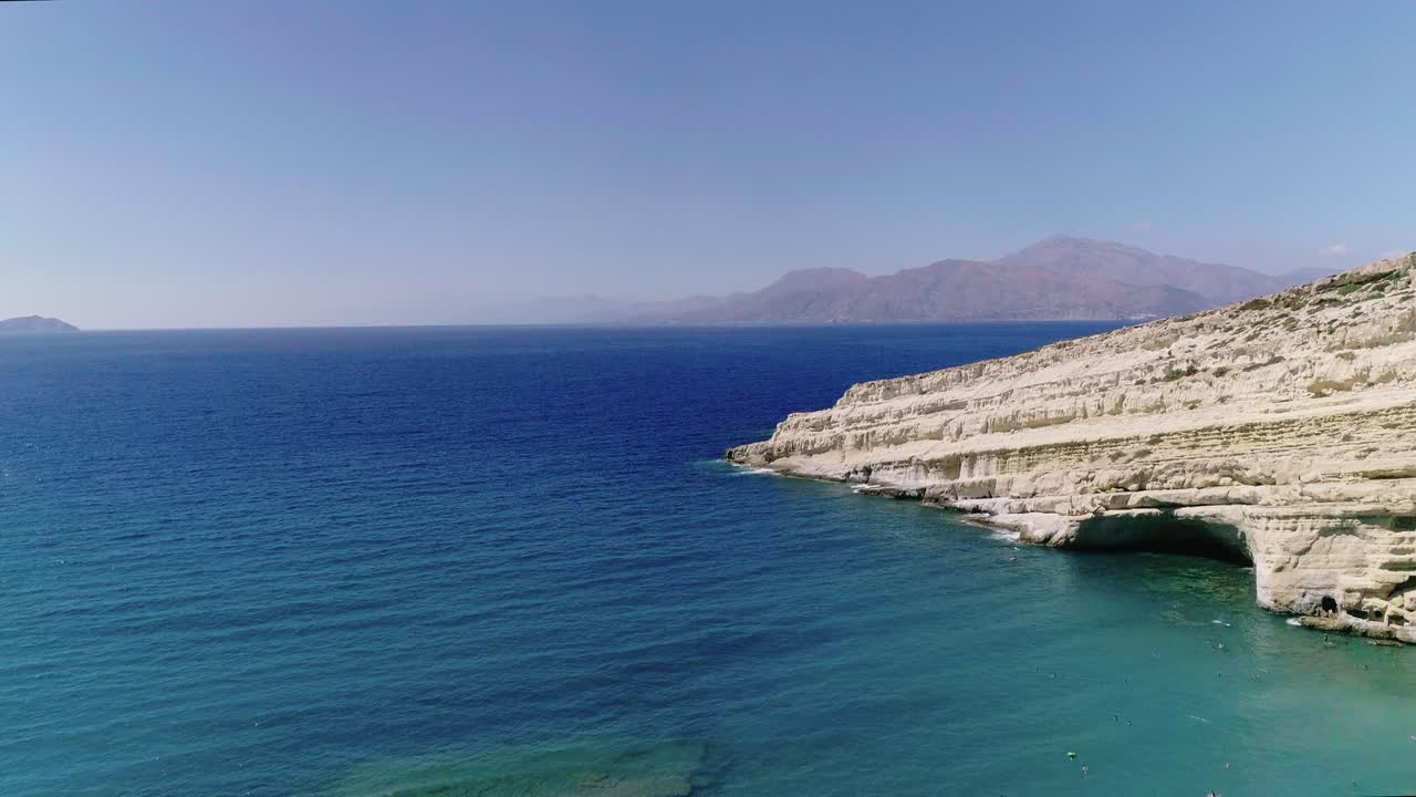 Beautiful view from a drone flying over the beach and bay in Matala Crete Greece