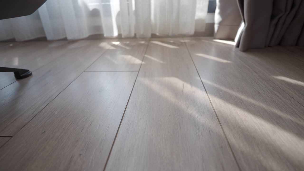 Sunlight and Shadows on a Light Wooden Floor