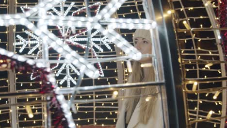 woman walking among the christmas lights and decorations