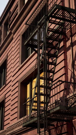 a red brick building with a fire escape