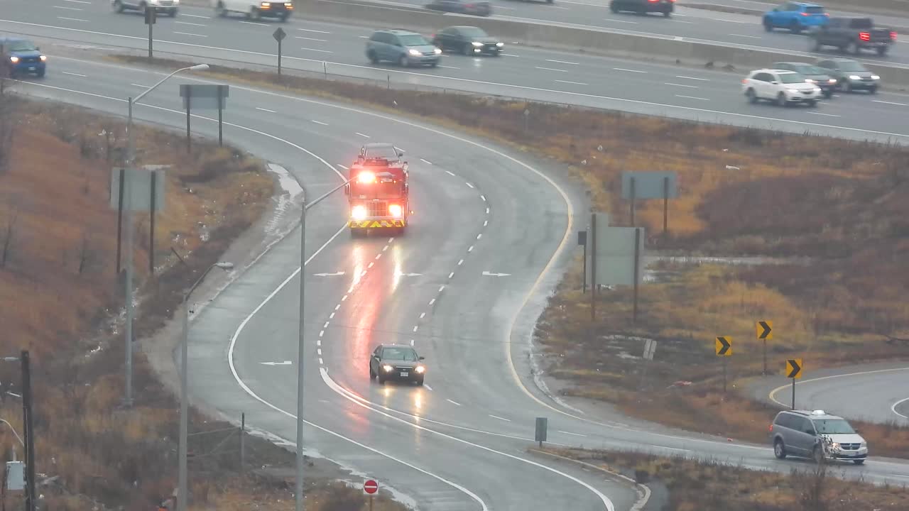 Fire Truck on a Curved Highway Ramp on a Wet Day