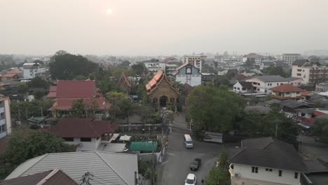 hazy aerial view of a temple and cityscape in southeast asia