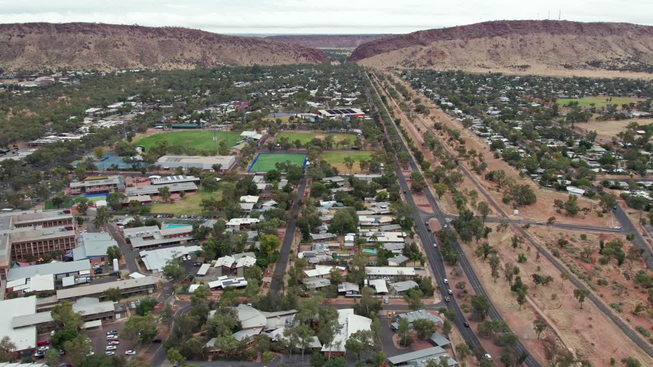 Drone view looking south over Alice Springs, looking south towards the MacDonnell Ranges and Heavitree Gap, Alice Springs, Mparntwe, Northern Territory, Australia. August 2022.