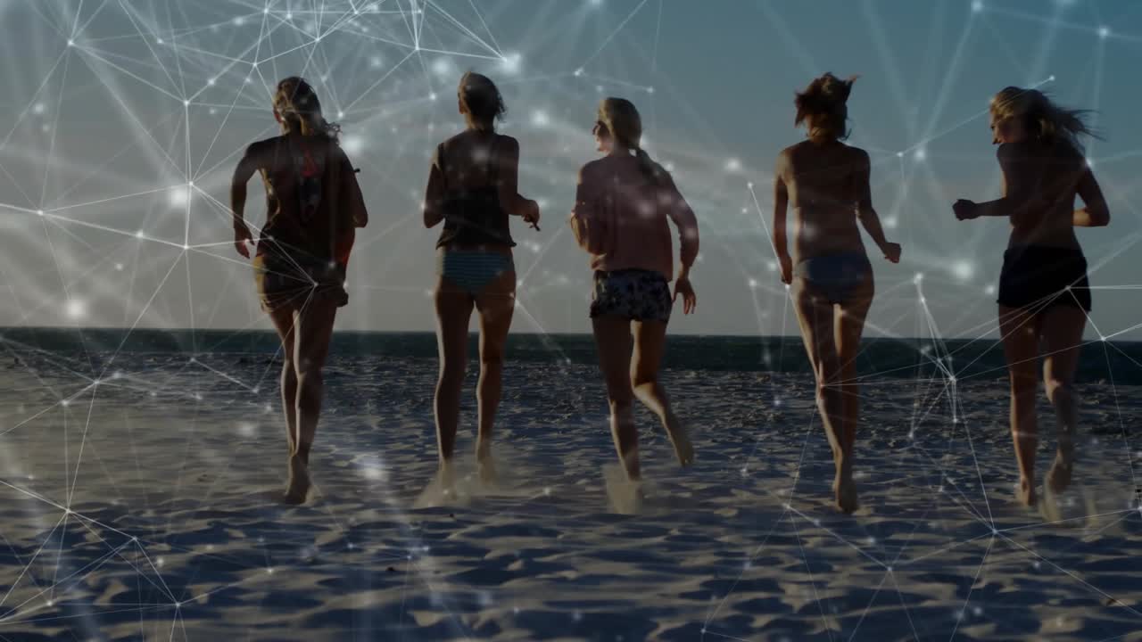 Group of five friends starting running toward surf on sand activating technology overlay for sunset
