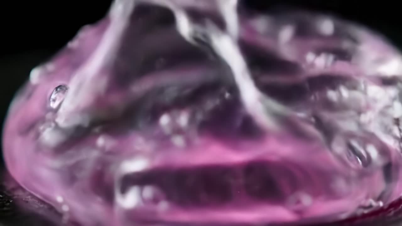 Detailed Close-Up of a Vibrant Pink Gel Blob With Bubbles and Reflections on a Dark Surface