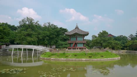 Hyangwonjeong-Pavilion-against-fluffy-colorful-clouds-at-sunset-at-Gyeongbokgung-Palace,-Seoul---tracking-shot