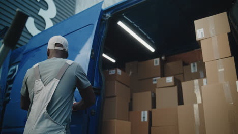 professional logistics workers organizing shipments from a commercial van