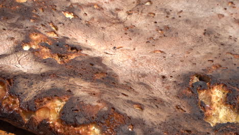 Indulge in the mouthwatering flavors of Tafarnoute, a traditional Moroccan Sahara bread, also known as the &#039;desert pizza