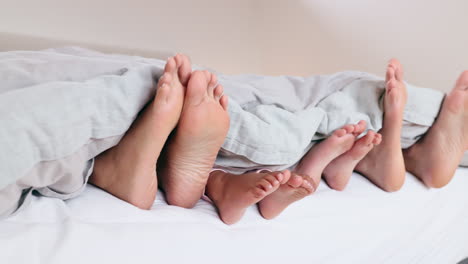 sleep, feet and family in a bed relax