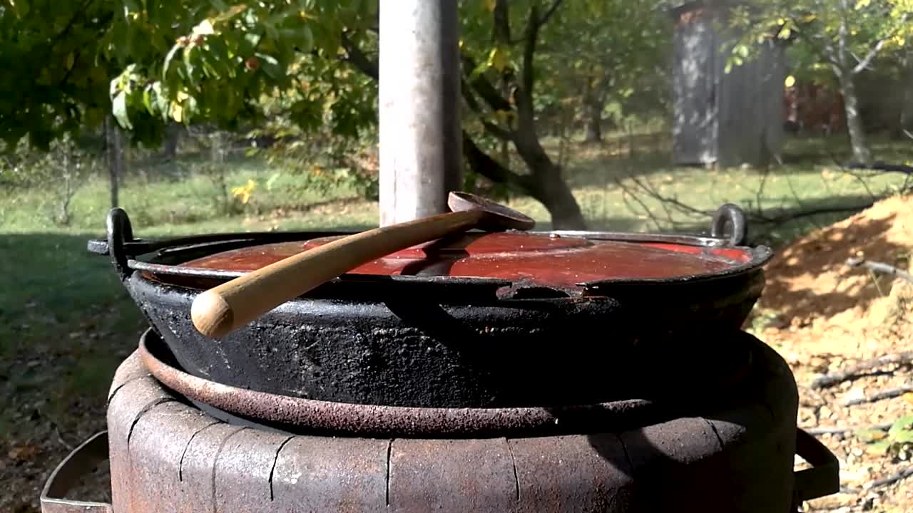 Steam coming out of an old fashioned rustic outdoor pot in the backyard, SLOMO