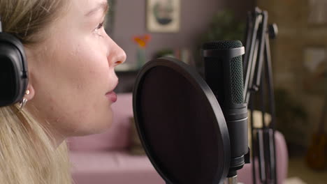 Close-Up-View-Of-Woman-Recording-A-Podcast-Wearing-Headphones-1