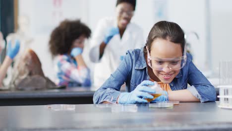 Biracial-schoolgirl-with-diverse-schoolchildren-and-teacher-during-chemistry-lesson,-slow-motion