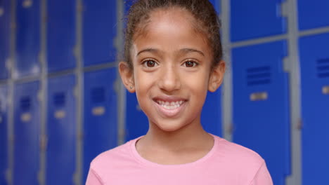 in school, young biracial female student is standing, smiling