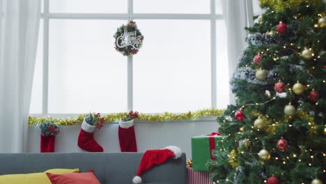 Video-of-christmas-greetings,-decorations,-christmas-tree,-lights-and-christmas-stockings-at-home