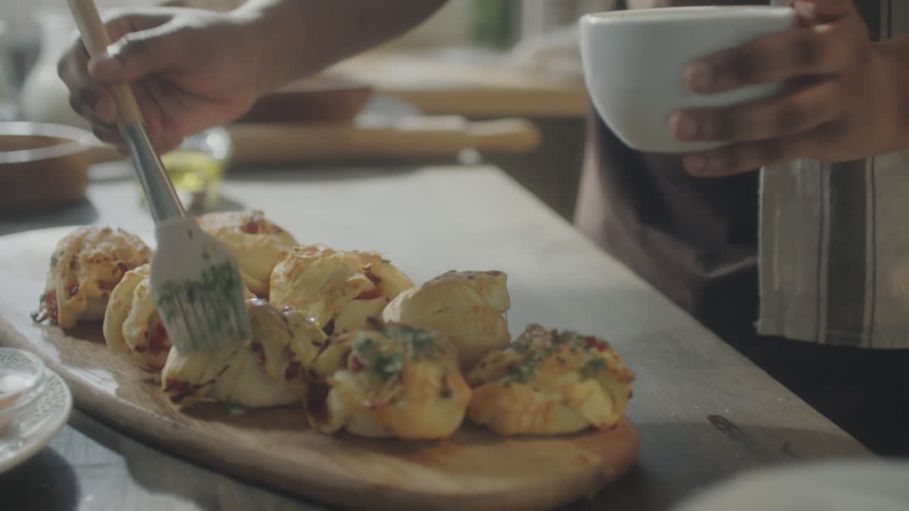 Brushing Garlic Butter Atop Freshly Baked Buns