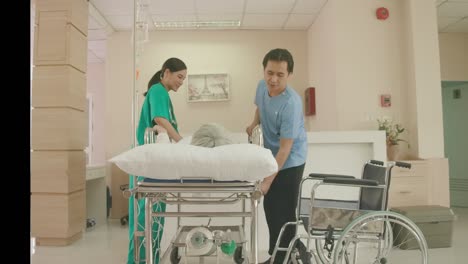 nurse and male nurse help an elderly woman get out of the bed to sit in a wheelchair after receiving treatment or health check. concept of health care, hospital, emergency medical, insurance, retired.