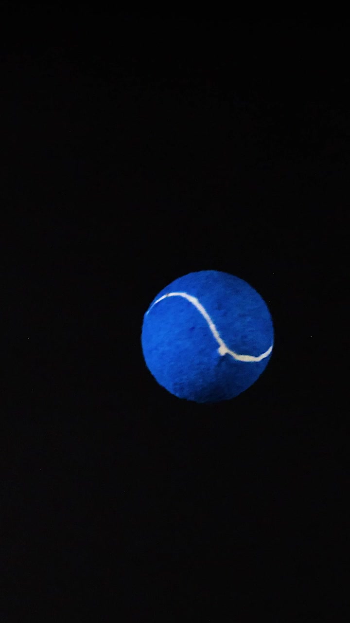 A blue tennis ball moves across frames