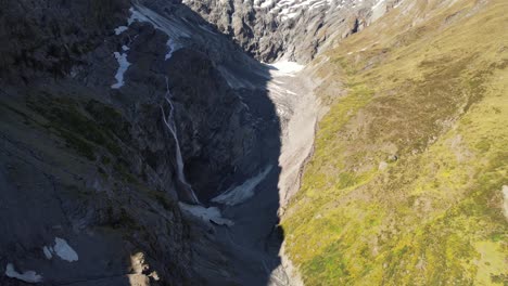 Aerial-scenic-reveal-snow-capped-mountain-peak-and-glacier,-beautiful-alpine-landscape,-New-Zealand