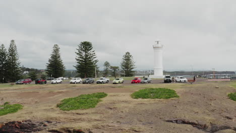 aerial drone shot tracking left closely around kiama lighthouse on a stormy day in south coast new south wales, australia