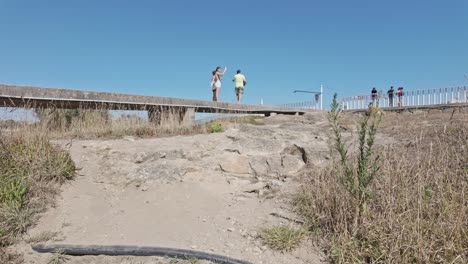 tourists walking near forte de são joão baptista in matosinhos on a sunny day
