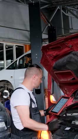 auto mechanic performing car diagnostics in a garage