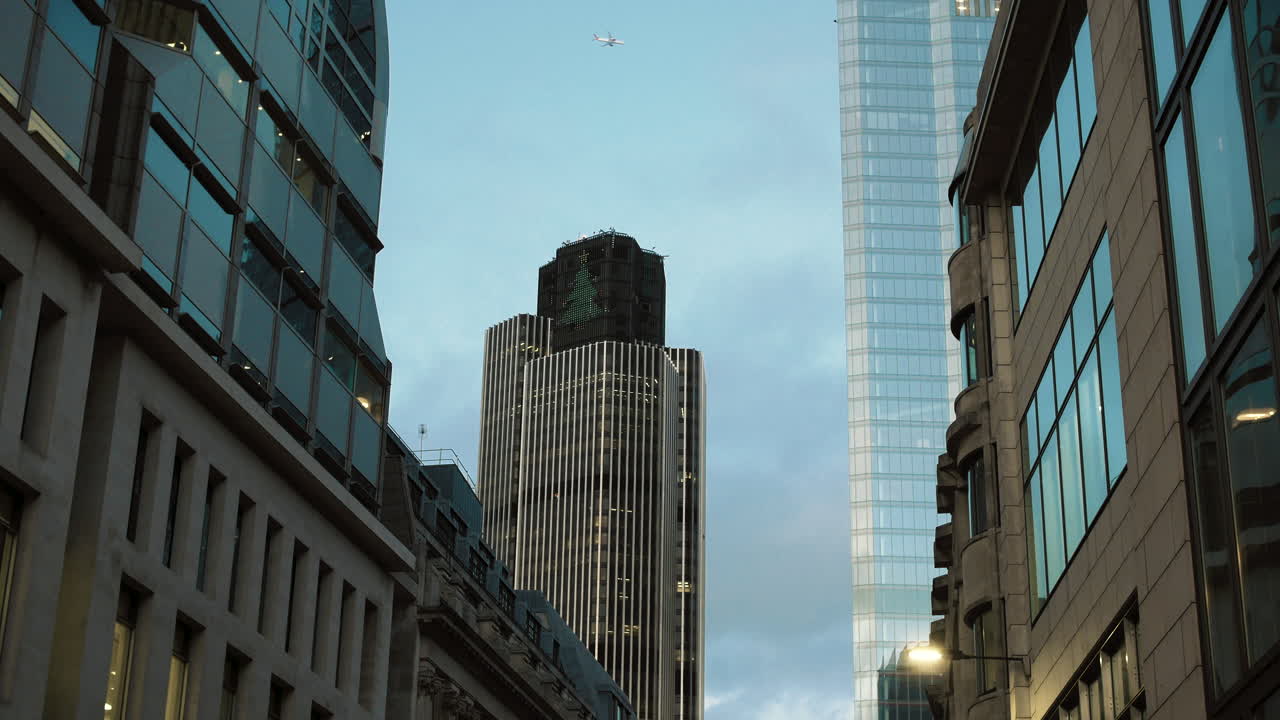 Still shot of city skyline skyscraper with commercial airplane flying over