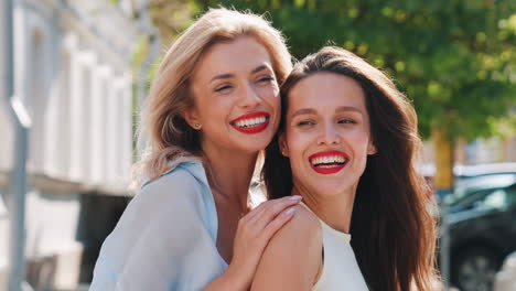 happy friends laughing in city street