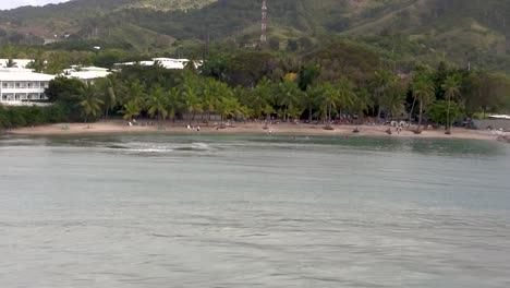 Drone-like-aerial-view-of-vacationers-relaxing-at-the-beach