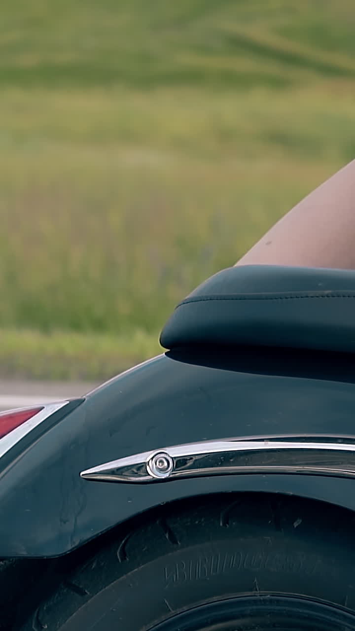 close view young woman in denim shorts gets off modern black motorcycle back seat behind man slow motion