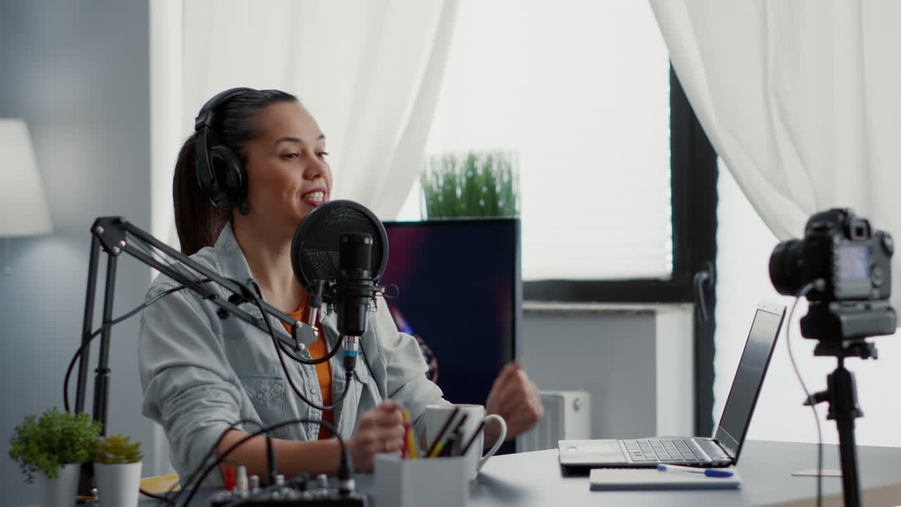 Famous vlogger sitting at home studio desk while recording video blog