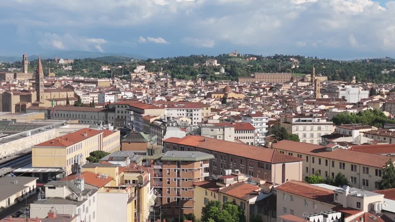 Aerial rising over Florence, Italy, horizon of terracotta rooftops and green hills