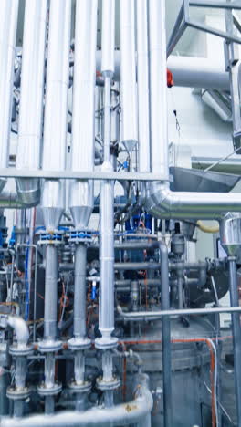 industrial dairy production. view on the steel pipelines on the milk factory. vertical video