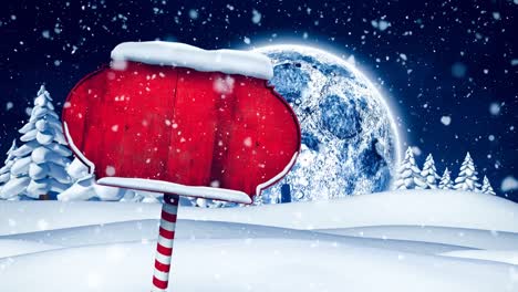 snow falling over red wooden sign post on winter landscape against moon in the night sky