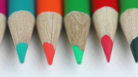 set of color pencils on white background - macro, panning shot