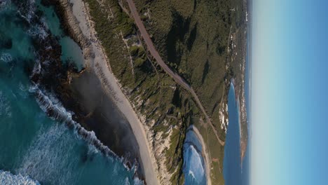 4k60 drone view of salmon beach and blue heaven beach in australia - vertical footage